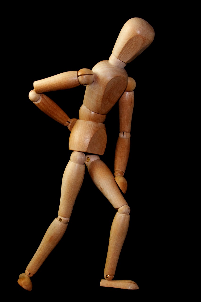 wooden figure indicating back pain